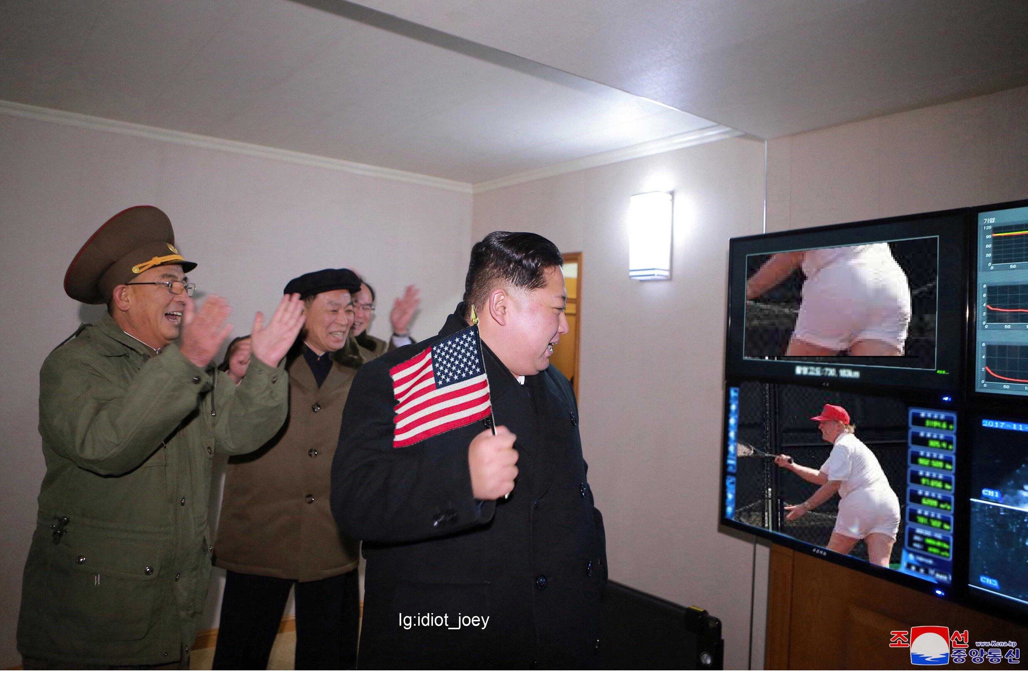 several men in military uniforms are watching a television screen