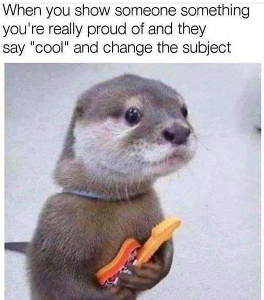 otter holding a carrot and a banana in its paws