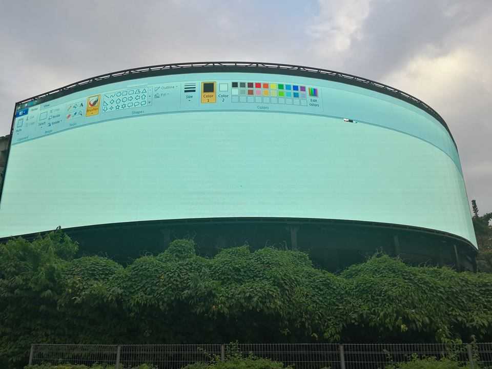 there is a large screen on the side of a building