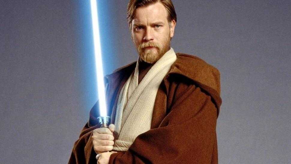 a close up of a man holding a light saber in his hand