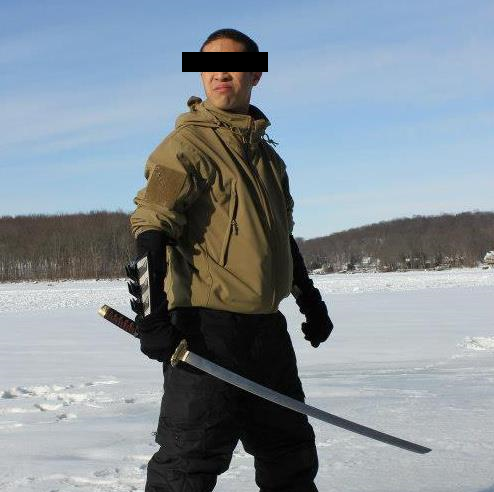 man in a tan jacket holding a sword in the snow