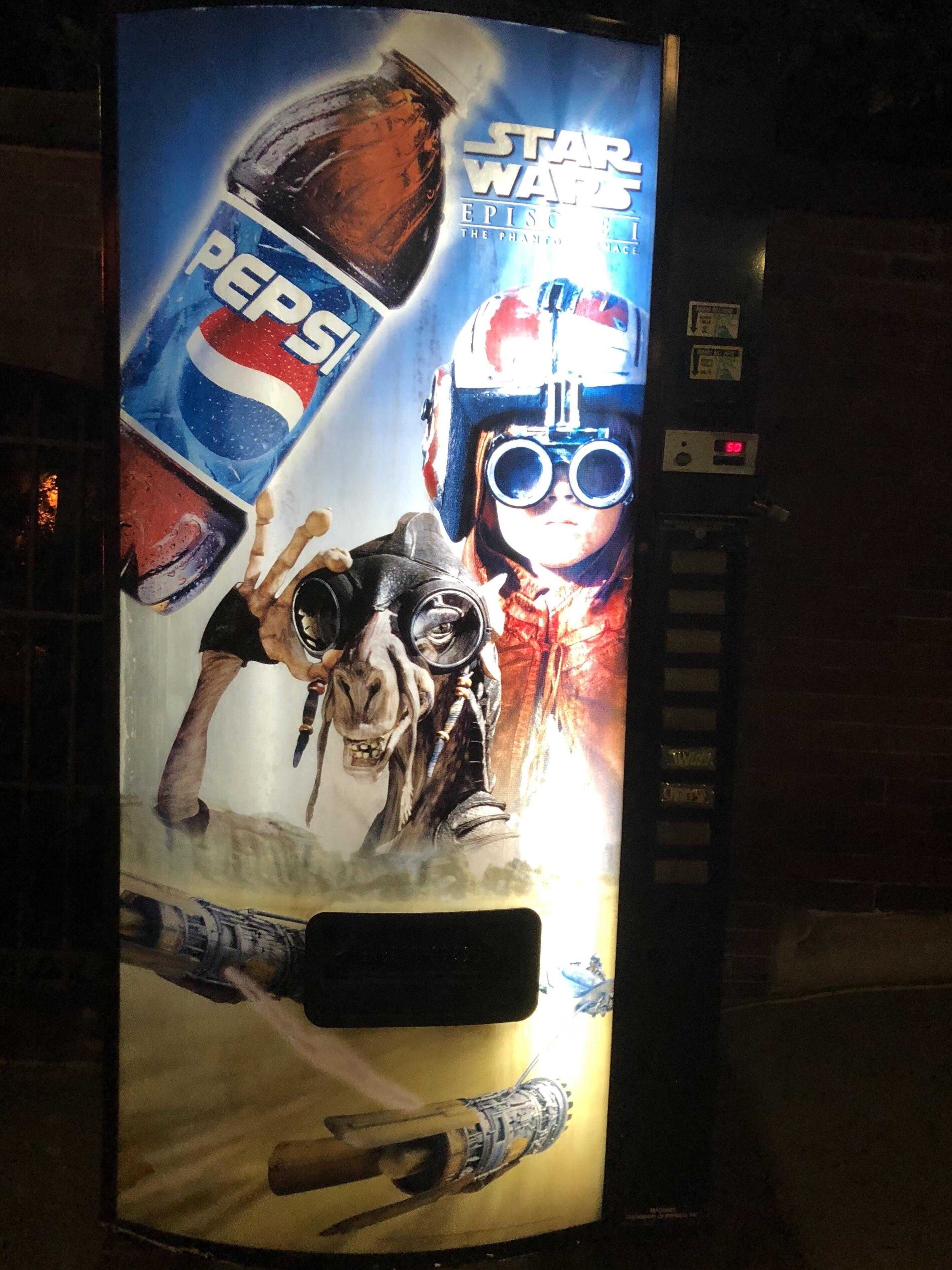 vending machine with a poster of a star wars movie