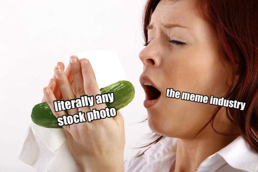 woman holding a cucumber in her mouth and biting into it