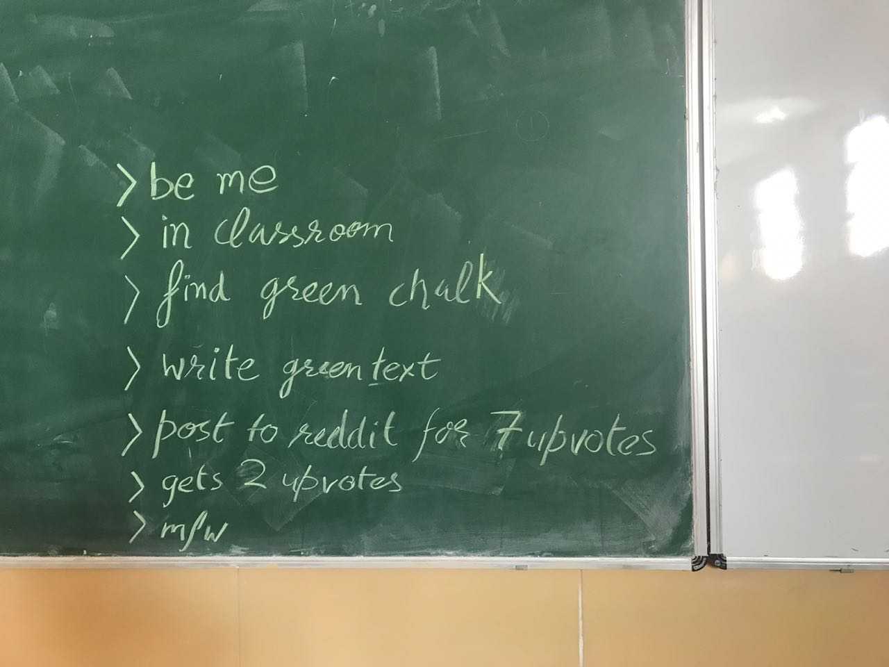 there is a chalk board with writing on it in a classroom