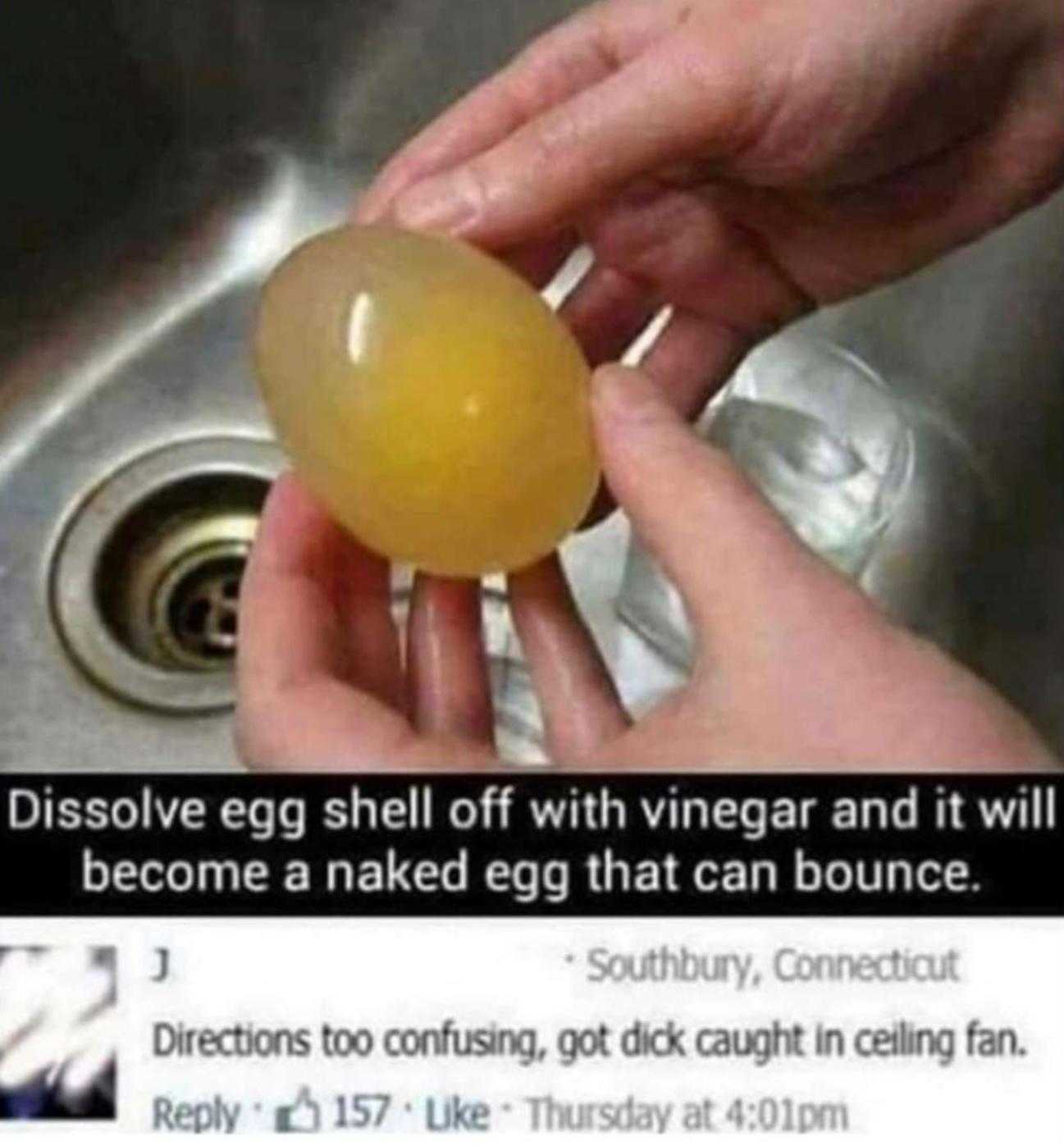 someone is holding a yellow egg in their hand in a sink