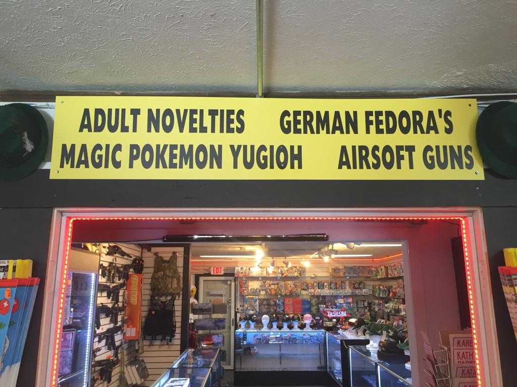 there is a sign above the door of a store that says adult novelies