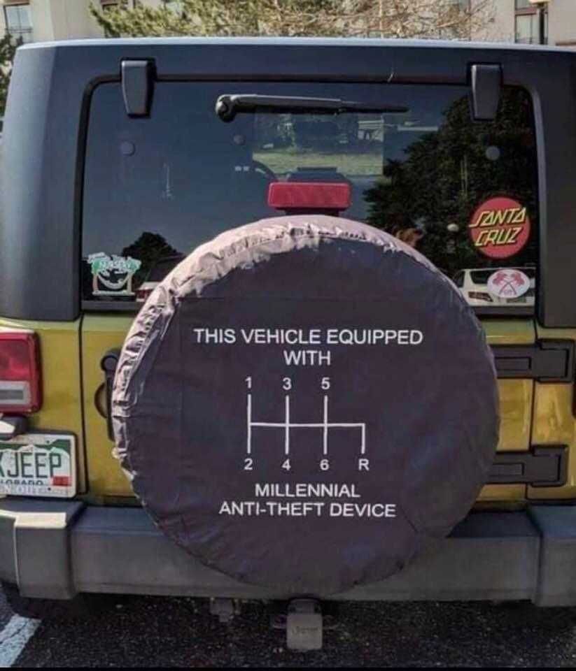 tire cover on a jeep with a sticker saying this vehicle equipped with 5 5 or millilennall device