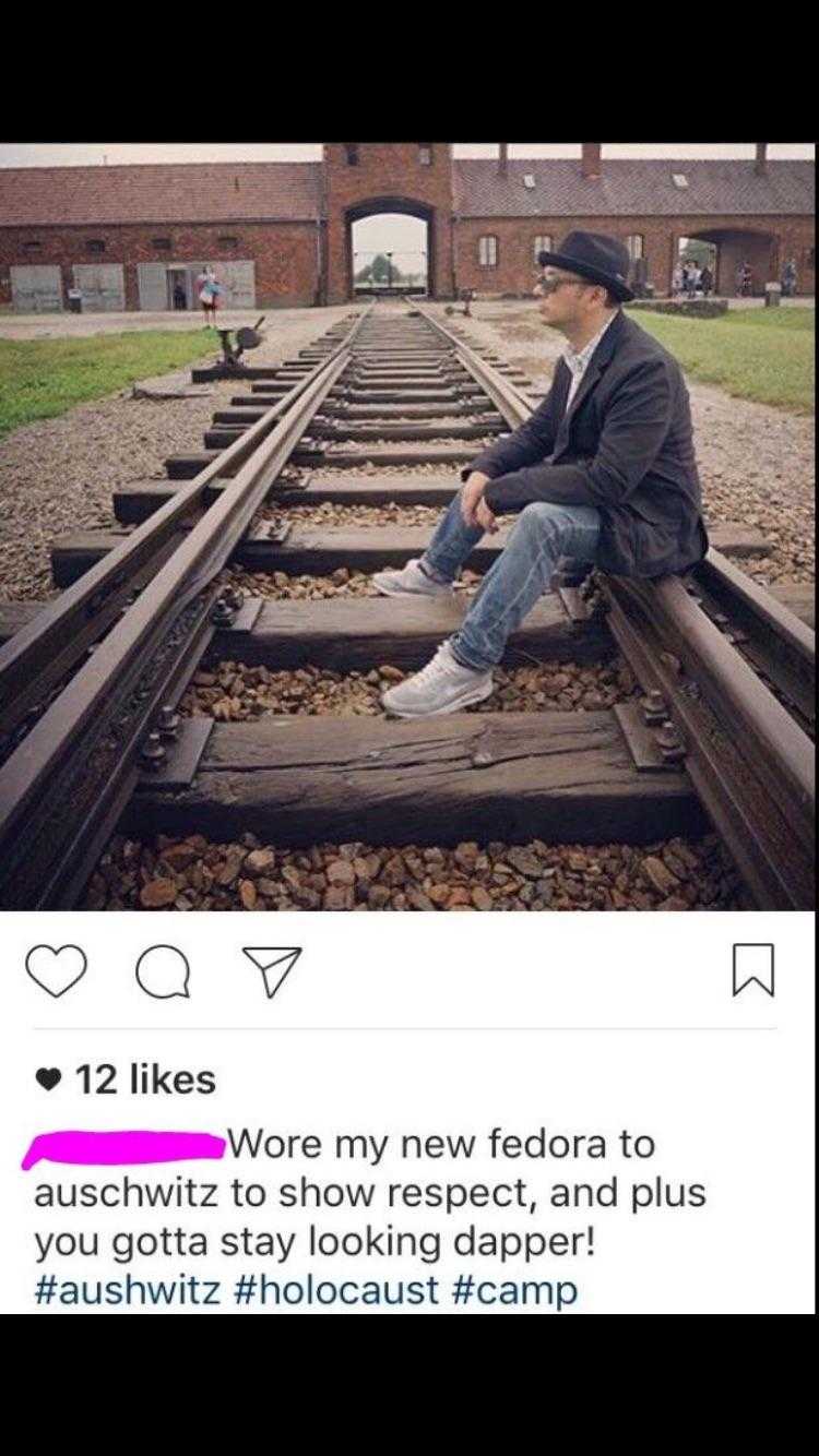 a close up of a person sitting on a train track