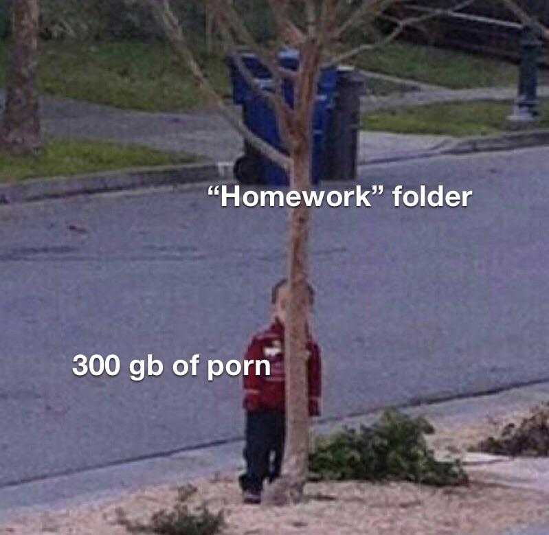 man standing next to a tree with a sign that says homework folder 300 gb of porn