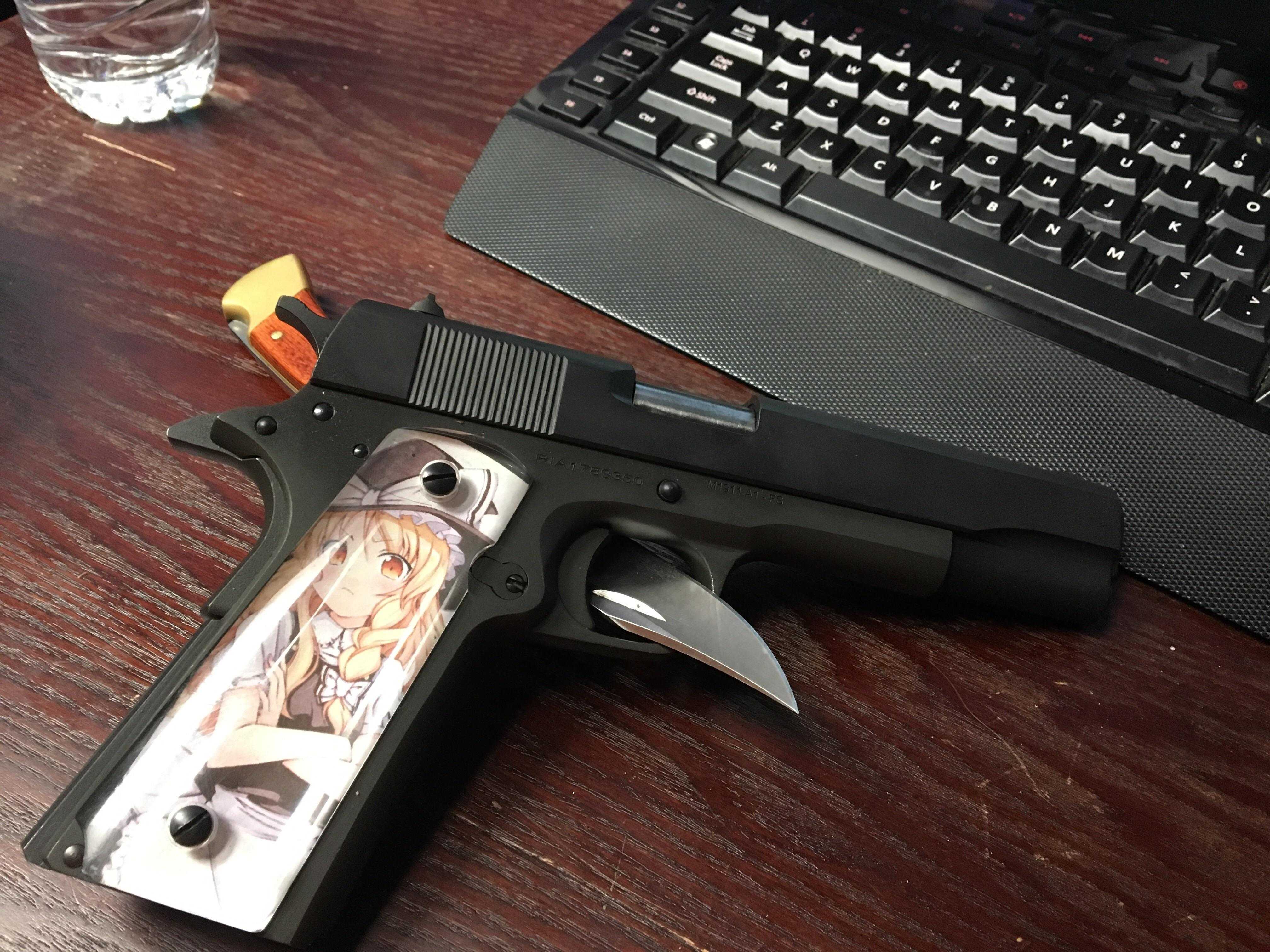 there is a gun with a picture on it sitting on a desk