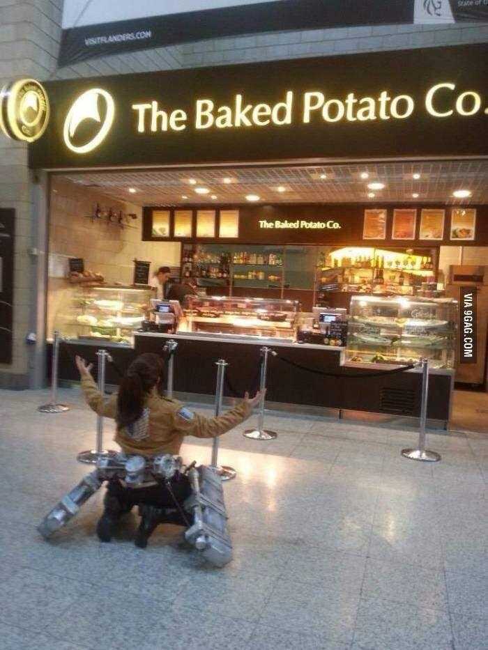 there is a woman sitting on the ground in front of a bakery