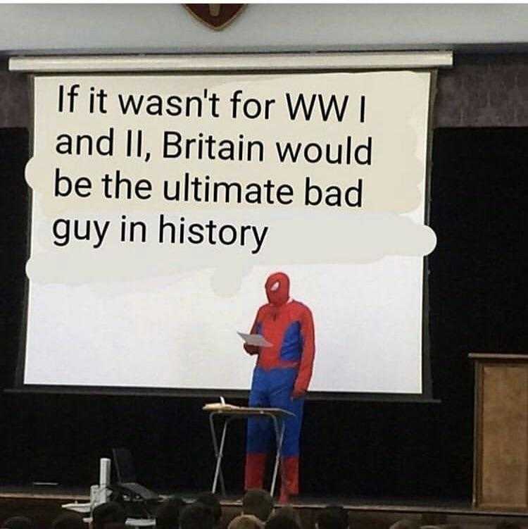 man in a spider - man costume standing on a stage with a laptop