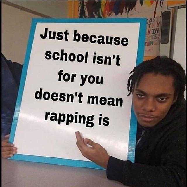 there is a man holding a sign that says just because school isn ' t for you doesn ' t mean rapping is