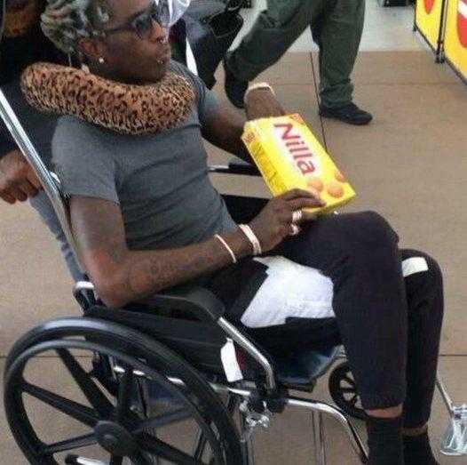 there is a woman in a wheelchair with a bag of chips