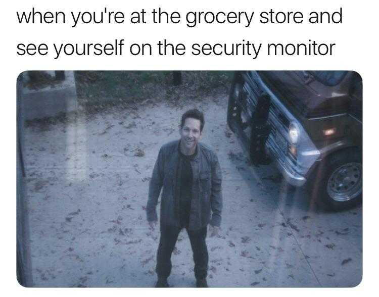 man standing in front of a parked car with a caption that reads when you ' re at the grocery store and see yourself on the security monitor