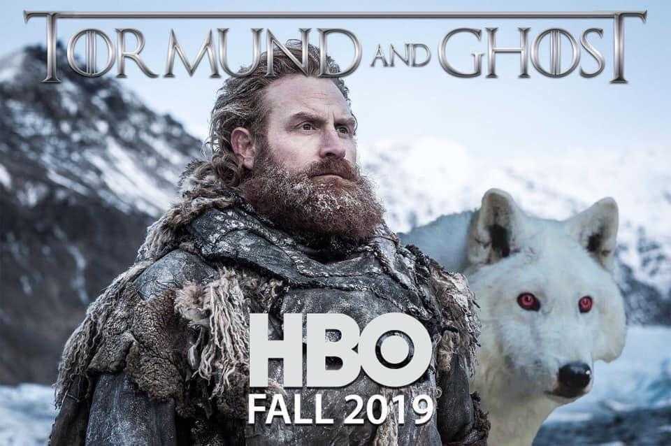 a close up of a man with a beard and a white wolf