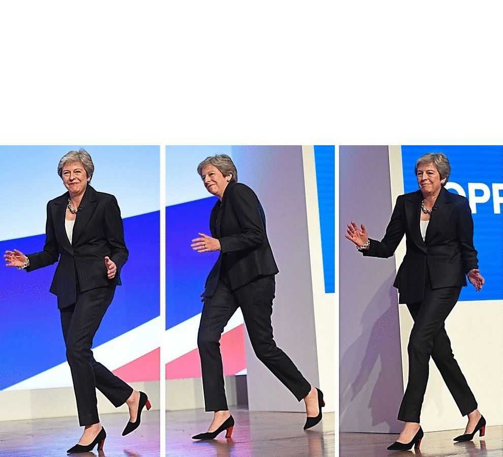 image of a woman in a suit walking on a stage