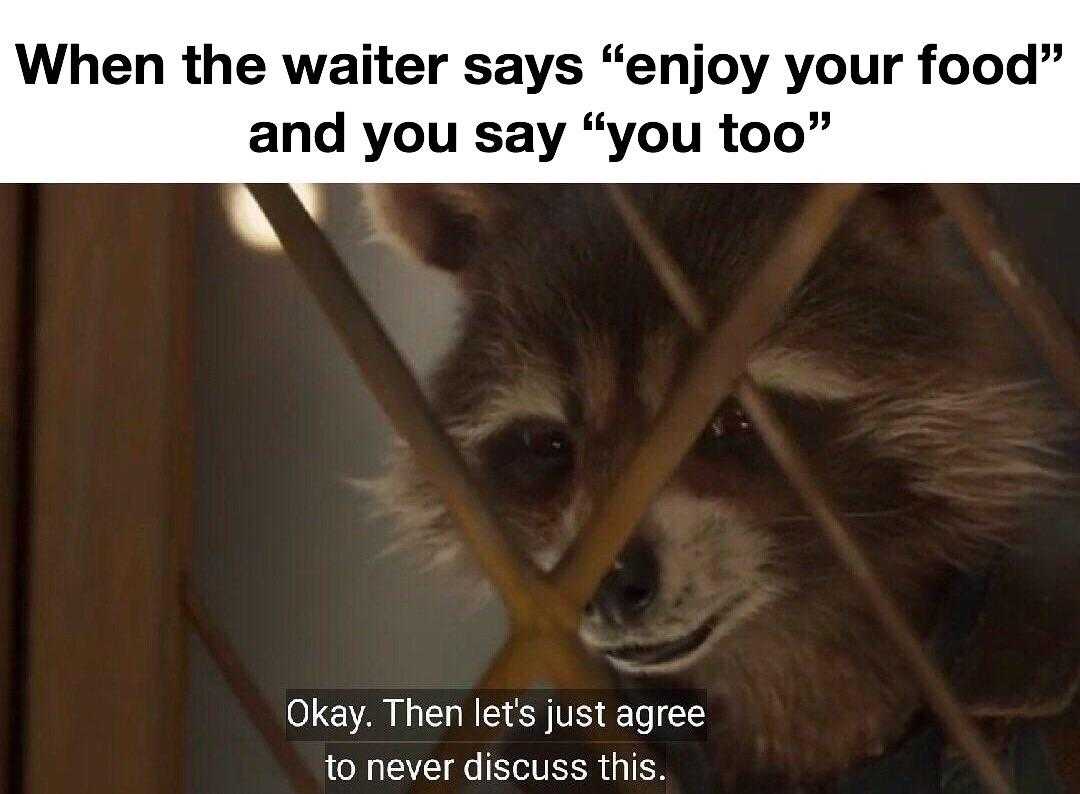 a close up of a raccoon looking through a fence with a caption that reads, when the water says enjoy your food and you say you ' too