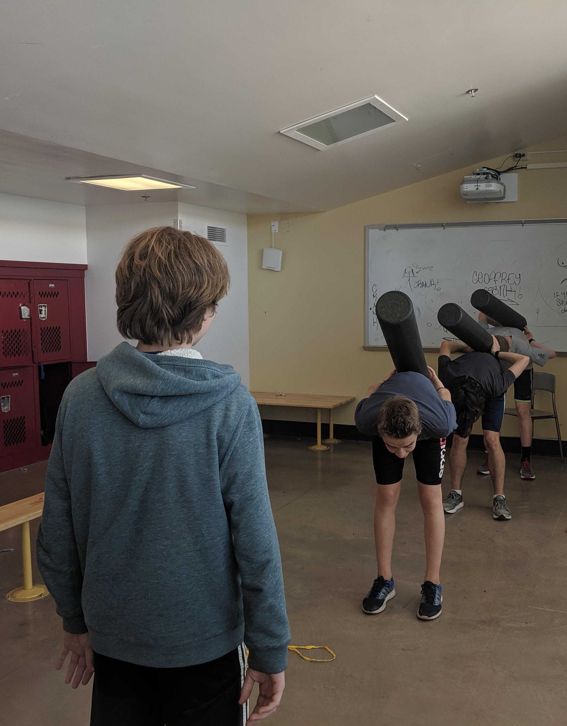 several people are doing a handstand in a classroom