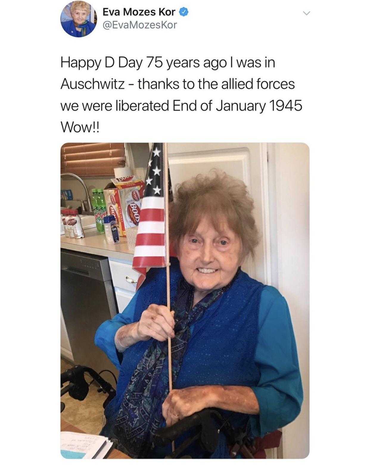 a woman holding a flag in a kitchen with a caption of happy d ' day 76 years ago was in auschwitzwz - thanks to the allied forces we were liberated end of january 1945