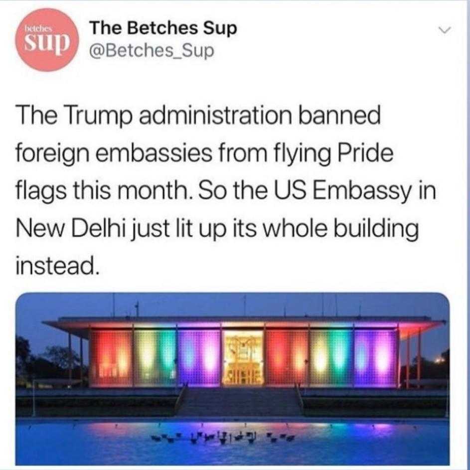 a tweet with a picture of a building with a rainbow lit facade