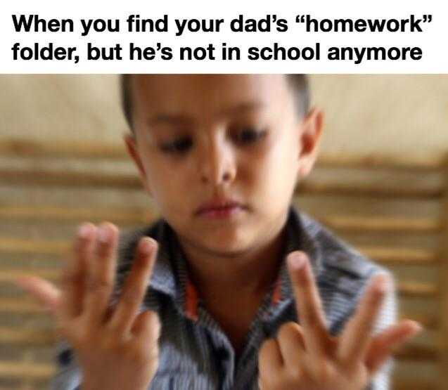 child making a sign with his hands while holding a cell phone