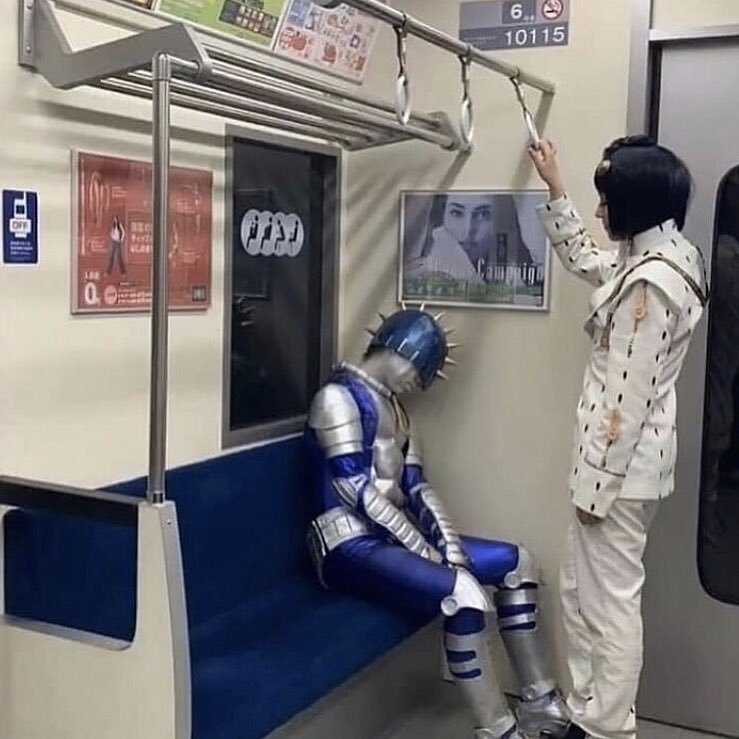 there is a man in a suit on a subway train