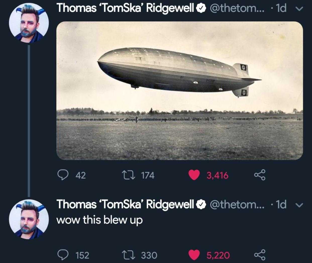 there is a photo of a man taking a picture of a large blimp