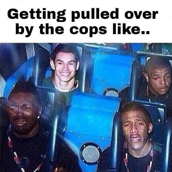 there are four men sitting on a roller coaster together