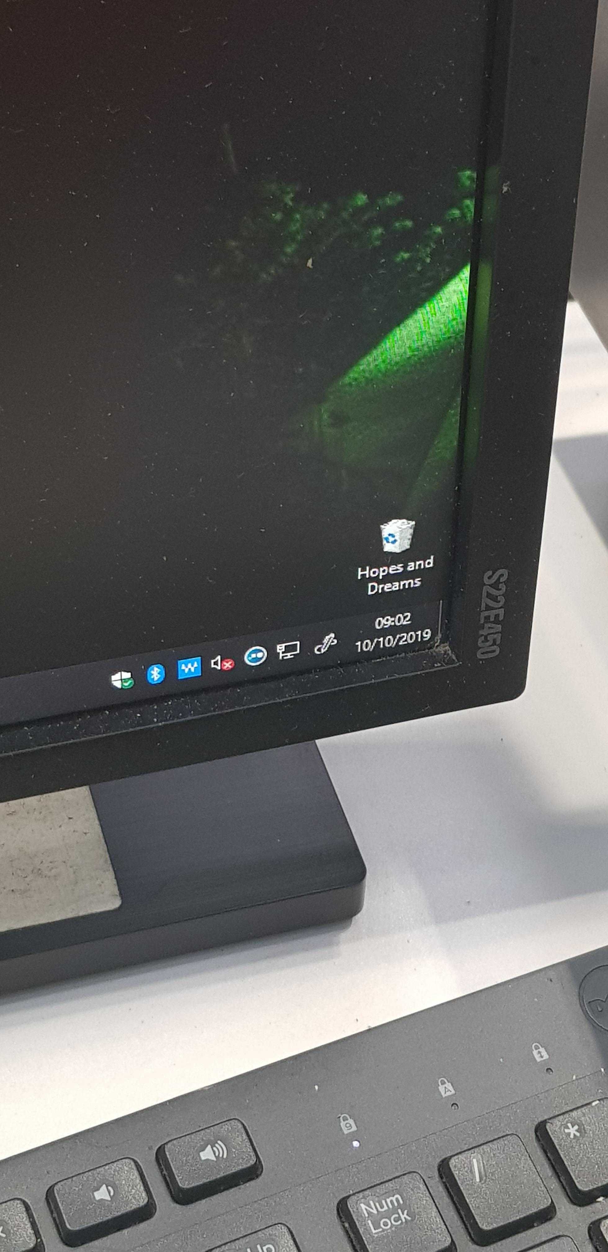 there is a computer monitor and keyboard on a desk