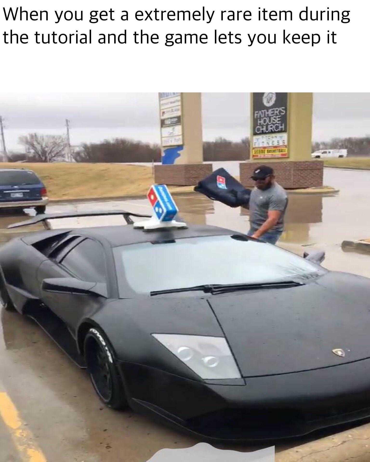 lamb car with a pizza box on top of it