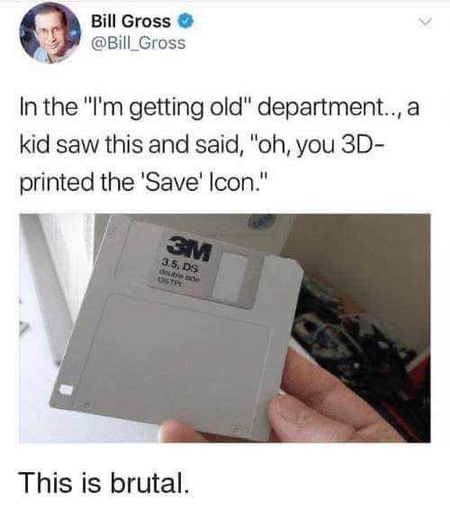 a close up of a person holding a floppy disk in their hand