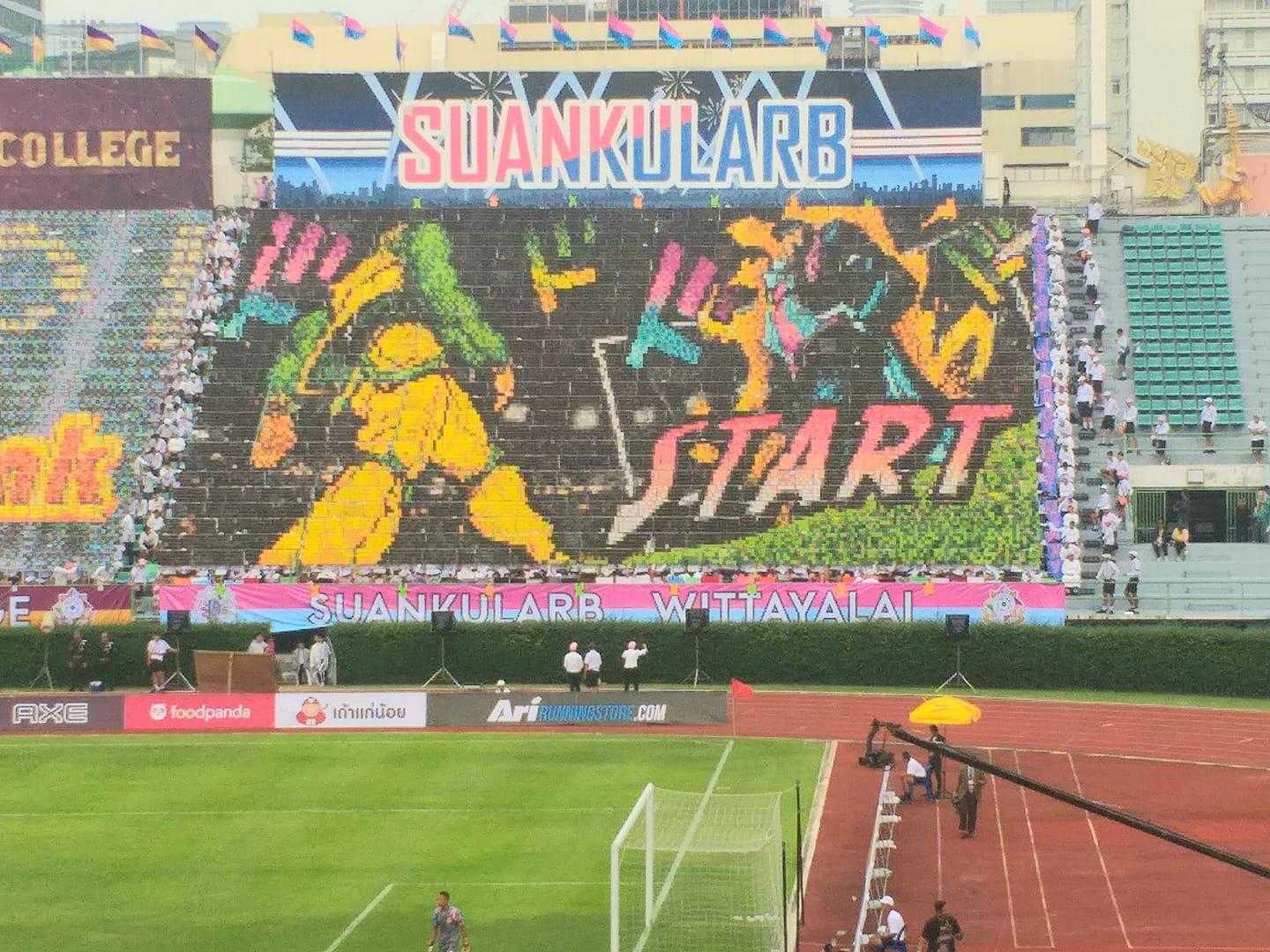 stadium with a large screen displaying a soccer game