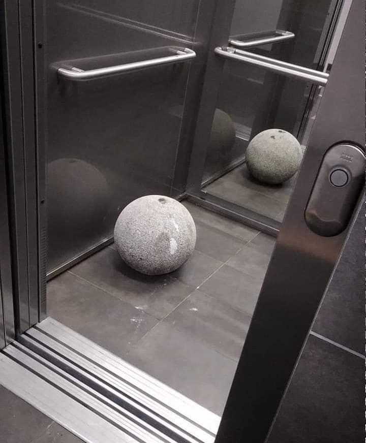 there are two rocks sitting on the floor in the elevator