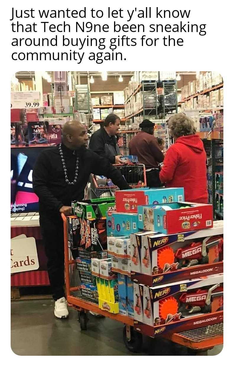 man pushing a cart with a cart of toys in it