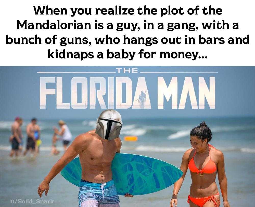 there is a man and a woman walking on the beach with a surfboard