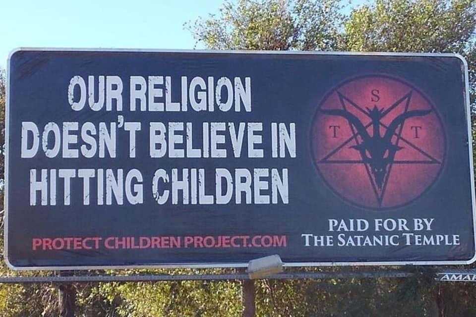 sign on a highway with a satanic message