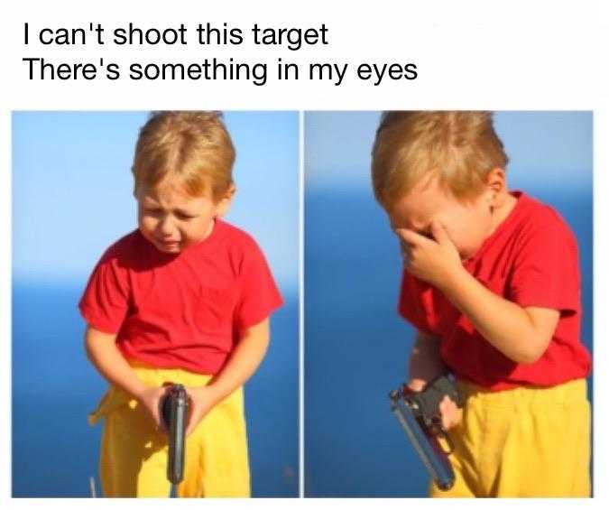 image of a little boy holding a gun and looking at something