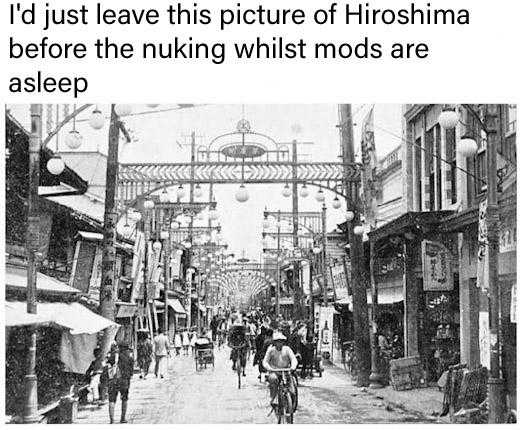 picture of a street with people walking and riding bikes