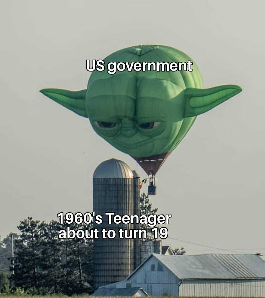 a close up of a green yoda balloon flying over a farm