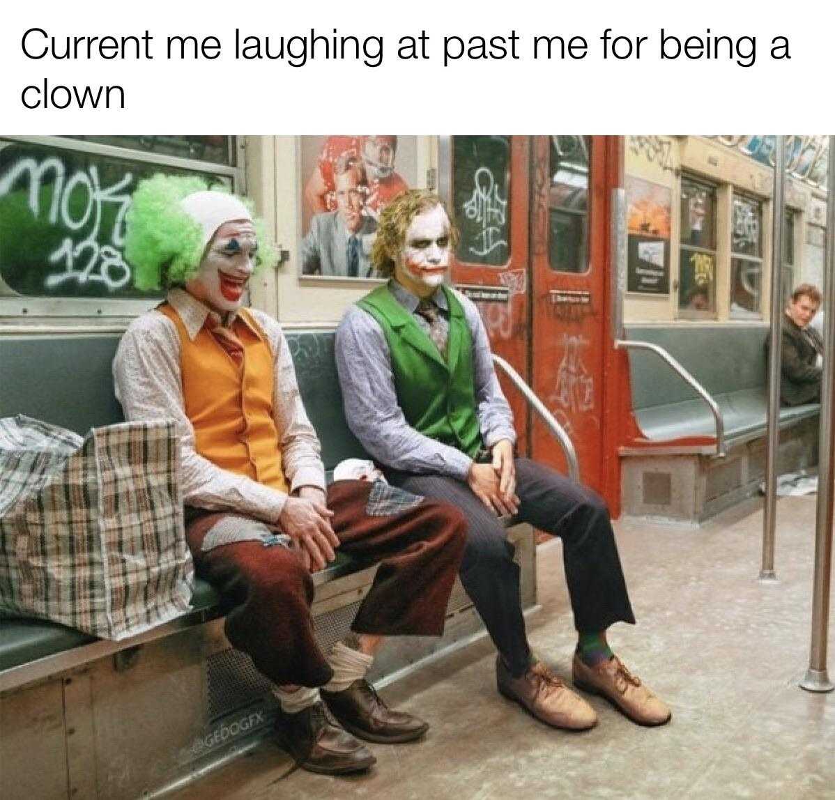 two men dressed as clowns sitting on a bench in a subway