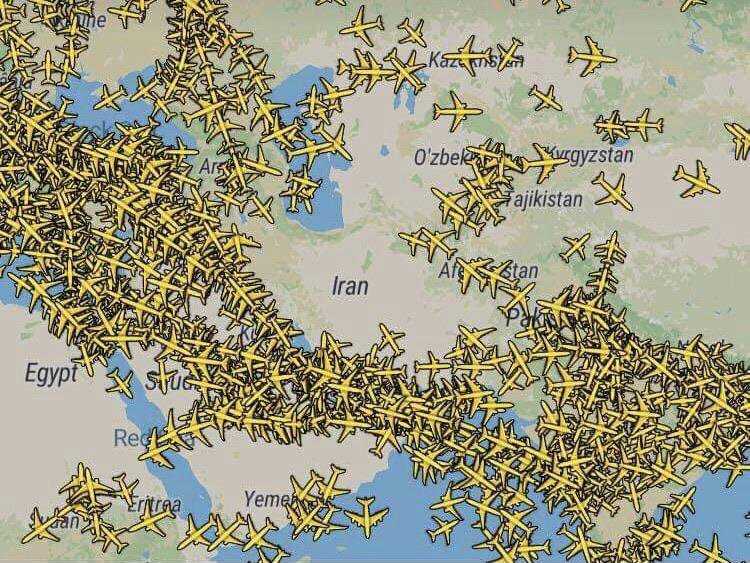 a close up of a map of the world with airplanes flying over it