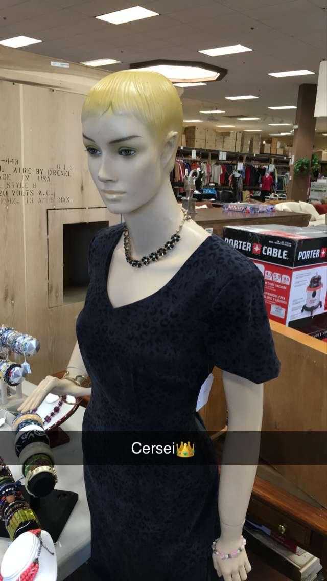 a close up of a mannequin in a store with a lot of jewelry