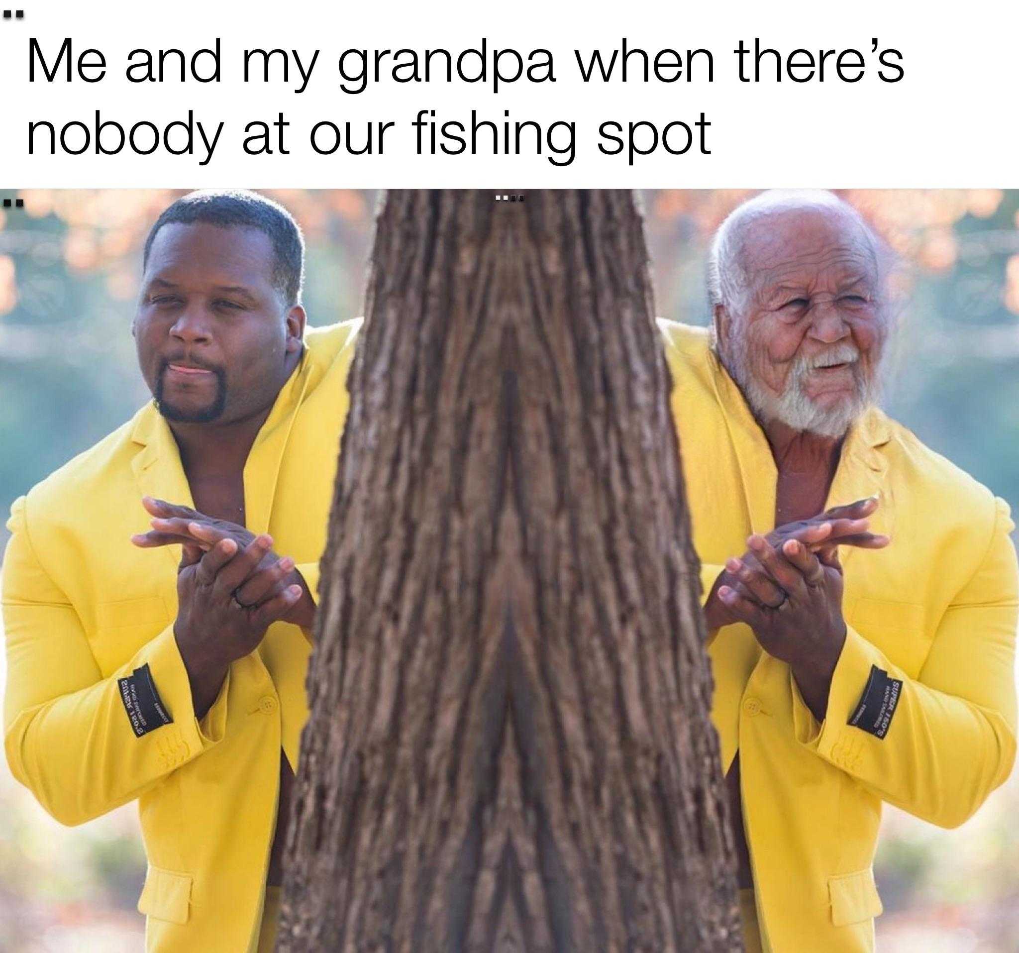 there is a man in a yellow shirt standing next to a tree