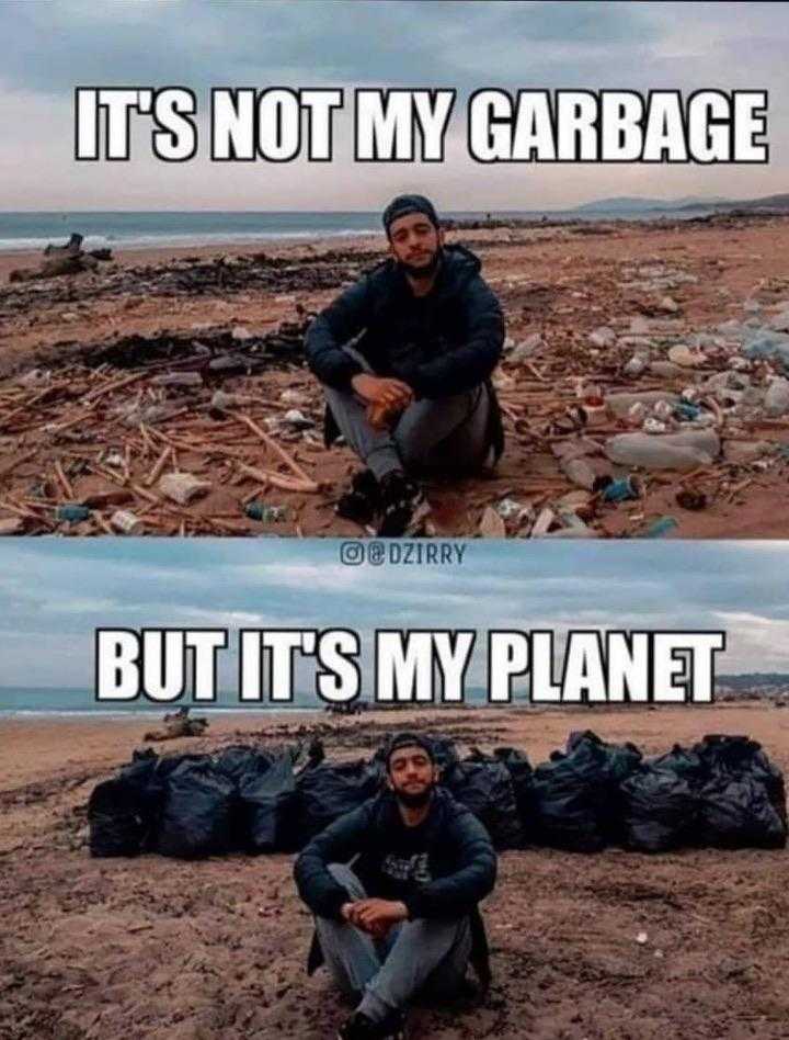 a man sitting on the ground next to garbage bags and trash bags