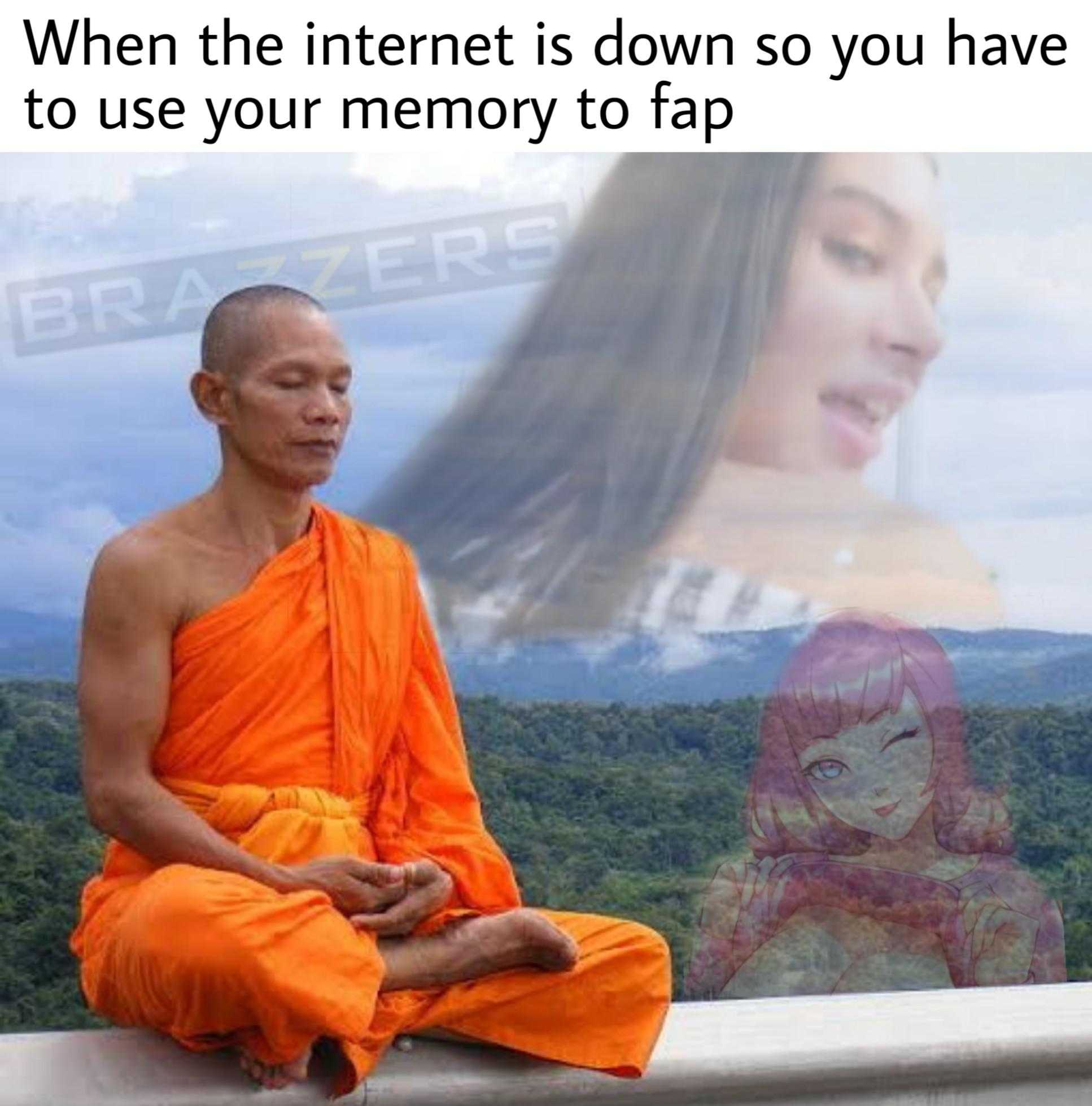 monk sitting on ledge with a picture of a woman in the background