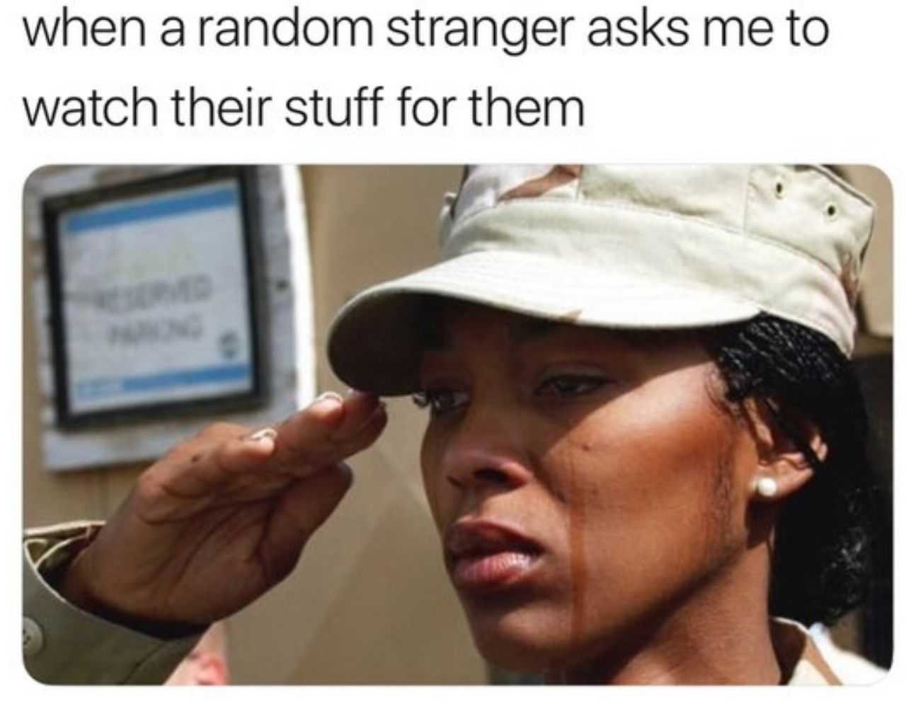 a woman in a military uniform putting a hat on her head