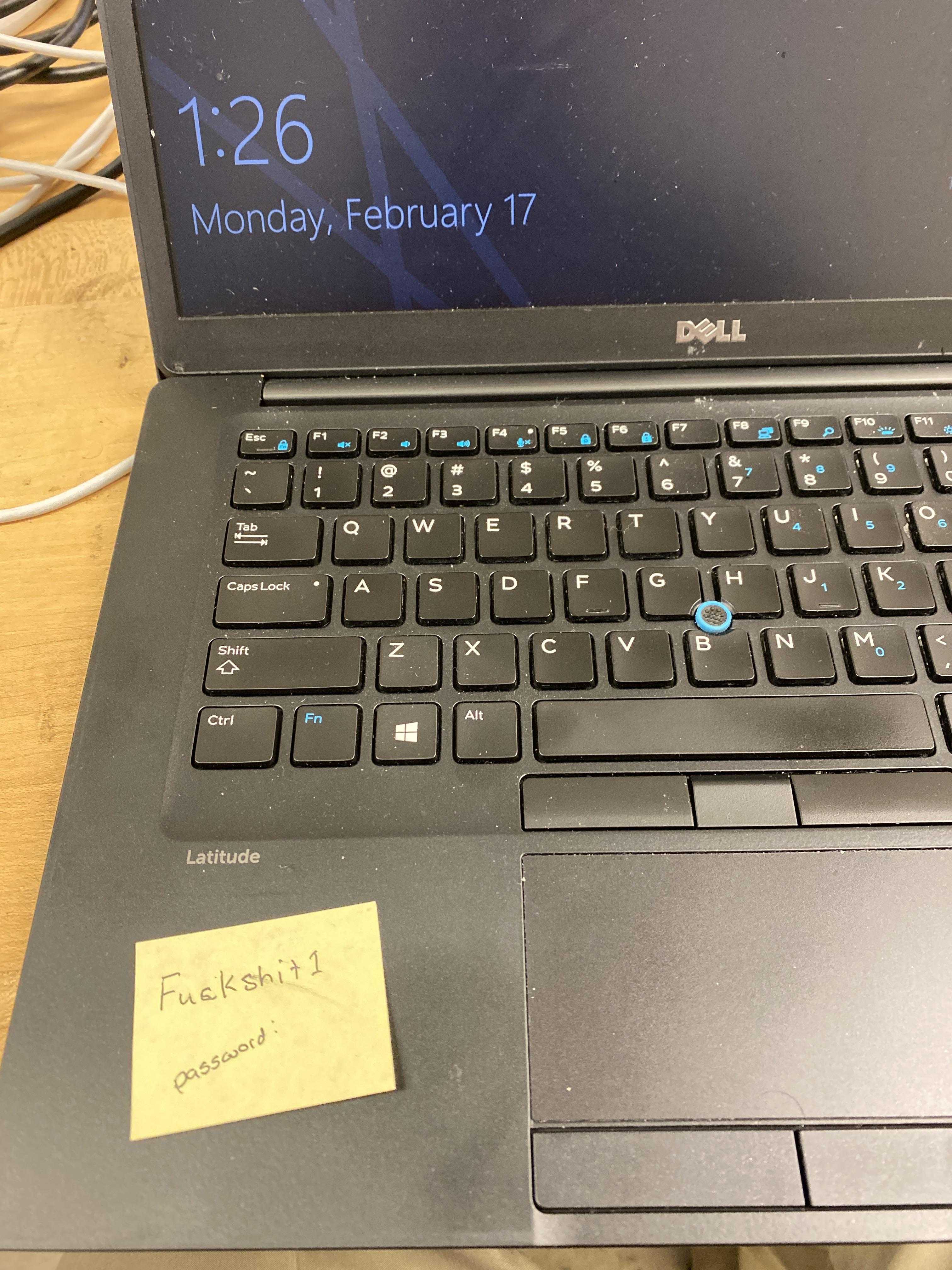 there is a laptop computer with a note on the keyboard