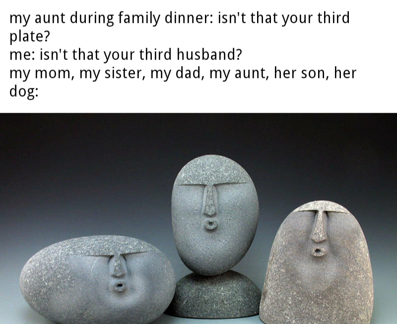 there are three stone faces on a table with a caption