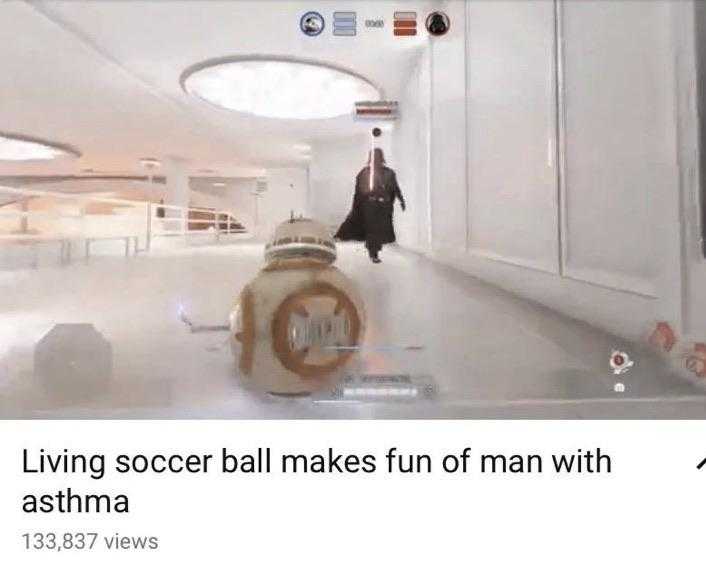 image of a man walking down a hallway with a bb - 8 robot